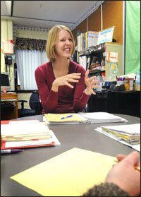 Jolene Comer, the principal of Lynnville-Sully Elementary and a middle school in the same building, takes part in a meeting to review student data.