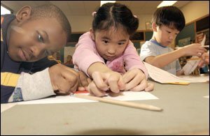 Montessori students like these at Milwaukee’s Craig Montessori Elementary take few formal tests, pursue their own work, and don’t get letter grades.