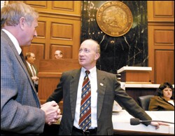 Indiana Gov. Mitch Daniels chats with Rep. Ralph Ayres following a speech on Jan. 19.