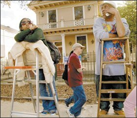 Robert J. Burvant, center, the chairman of the board of a new charter school opening in New Orleans, scouts for potential students along a Mardi Gras parade route.