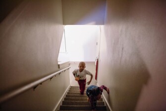 Kindergartner Jason Gantt, and 3-year-old Brooklyn Gantt, run up the stairs to play house at their home in Tacoma. “Kids, they feel things,” says Bobby Gantt of the family’s formerly mobile life. “We wanted to make sure these kids didn’t carry our burden.”