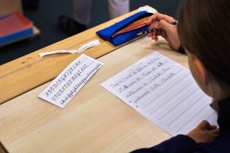 A child practices handwriting at the Djurgardsskolan elementary school in Stockholm, Sweden on Aug. 31, 2023.