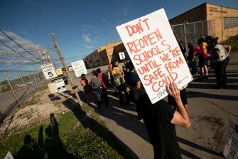 Demonstrators block the driveways of the Detroit public schools bus terminal to keep school buses from running on the first day of summer school. Concerns about COVID-19 and a lack of safety measures prompted the protesters to demand that schools close.