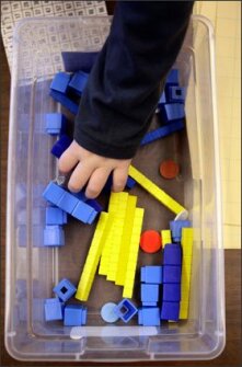 A 2nd grader at Broadwater Elementary School in Helena, Mont., reaches into a bin for visual aids to help him solve a math problem.