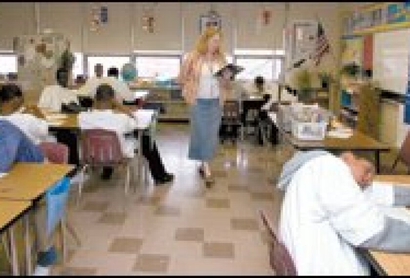 Vanessa Skrat, a language arts and social studies teacher at the Options Complex at the Margaret A. Ireland School in Cleveland, reads a story to her class.
