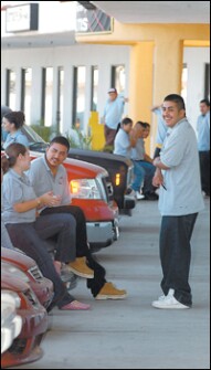 Fernando, left, and Ricardo Moreno spend a short break during the school day with friends. The Cesar Chavez students pass most of their breaks hanging out in front of the strip mall where the school is located.