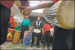 Members of the Azania Drum Ensemble hold hands during morning assembly at the Betty Shabazz International Charter School, which research Carol D. Lee helped found. Ms. Lee has drawn on her experiences at the Chicago school for her research on using features of urban African-American culture to bolster classroom learning.