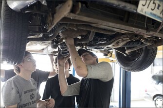 Students in the Advanced Automotive class repair a vehicle in the Tech Annex at Burnsville High School.