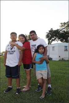 Twelve-year-old Juan Pablo Pacheco, his mother Maritelma Ixmatlahua, father Juan Pacheco, and sister Ruby Pacheco, 7, pose in their neighborhood in Foley, Ala. They are among the many Latino families in their rural community that are feeling the fallout from a new state law targeting illegal immigrants.