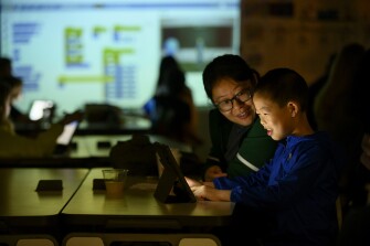 Vick Xin, 8, works on a computer animation with his mother, Liqun Tang, at “Creative Coding: A Morning of Making” as part of a Remake Learning Days program held at South Fayette Intermediate School on May 23, 2022 in McDonald, Pa.