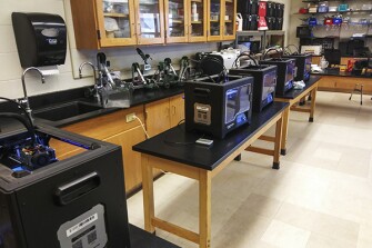3-D printers at the South Shore Vocational Technical High School in Hanover, Mass. Lead engineering teacher Jerry Shaw is one of the teachers using those printers to make face shields for healthcare workers.