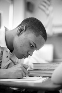 Alamin Smith works on a history lesson in class at Kelvyn Park High School in Chicago, where the school district provides high schools with detailed information to monitor 9th graders’ progress and support them on a path to graduation.