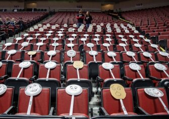 The Auburn fan section got creative by placing paper plate faces on the seats during the Class 1C boys high school basketball tournament championship game against Ogallala at Pinnacle Bank Arena, March 14, 2020, in Lincoln, Neb. Crowds were limited to staff and immediate family due to concerns over the coronavirus.