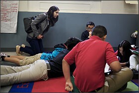 Martine Gordon, a prospective charter school board member, talks with students while visiting a classroom during a tour of Chavez Prep Middle School in the District of Columbia.