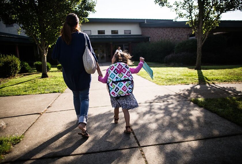 Autumn Edwards and her mother, Lindsey Edwards, walk into Prairie Mountain School in Eugene, Ore. The school offers a transition program that gives children a chance to practice kindergarten-level social skills before starting school.