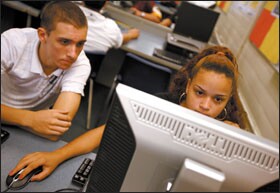 Senior Jessica Steinmann, bottom at right, and junior Marcos Rego work on computer-generated building designs during their civil-engineering and architecture course.