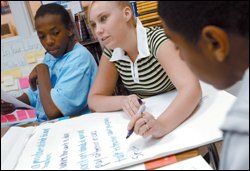 Tambra Synder, center, Dontez Gaffney, left, and Alex Walton read and discuss letters of advice from seniors who wrote to the 9th grade class at Waggener Traditional High School about how to be good students.