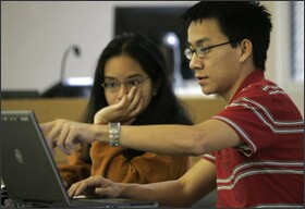 Kristle Valderrama and Minh Dang work on an exercise for a UTeach class.
