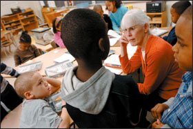 Marti Galvin listens to a question from a pupil as she sits with children at the beginning of the school day. In a typical Montessori school, children are organized into multiage groups.
