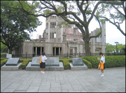 In Hiroshima, Swope came across the "remains of a brick-and-stone building, a former exhibition hall, one of the few structures left standing" after the city was bombed on August 6, 1945.