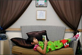 Pupil Melany Parra, 4, reads at the Miller center.