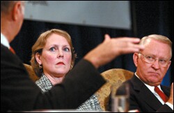 Moderator David R. Gergen gestures during a panel discussion on workforce preparation with Melanie Holmes, a senior vice president of Manpower Inc., and U.S. Rep. Howard P. "Buck" McKeon.