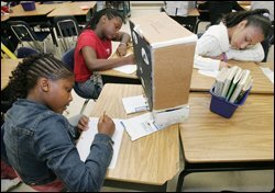 Daija Lee, left, Ashley McClendon, and Fatina Sanchez, right, work on a project in their class at Martin Luther King Jr. Middle School in Atlanta last May. For the past three years, more than 400 sixth and seventh-grade students in the school have been divided into single-gender classes.