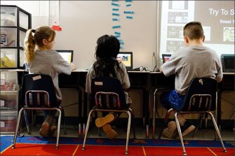 First graders Arissa Alim and Brayden McDonald play Keenville at Newnan Crossing Elementary School. As part of the game, students acquire virtual jelly beans for correct answers, which they can then use to purchase accessories for their avatars.