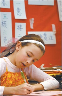 Sixth grader Emma Ivie works on a social studies project in Chinese at Hosford Middle School in Portland, Ore., one of the few districts to offer the language.