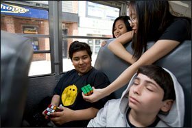 Russell Sage Junior High School students relax during a bus ride to the New York Aquarium to gather material for a science project.