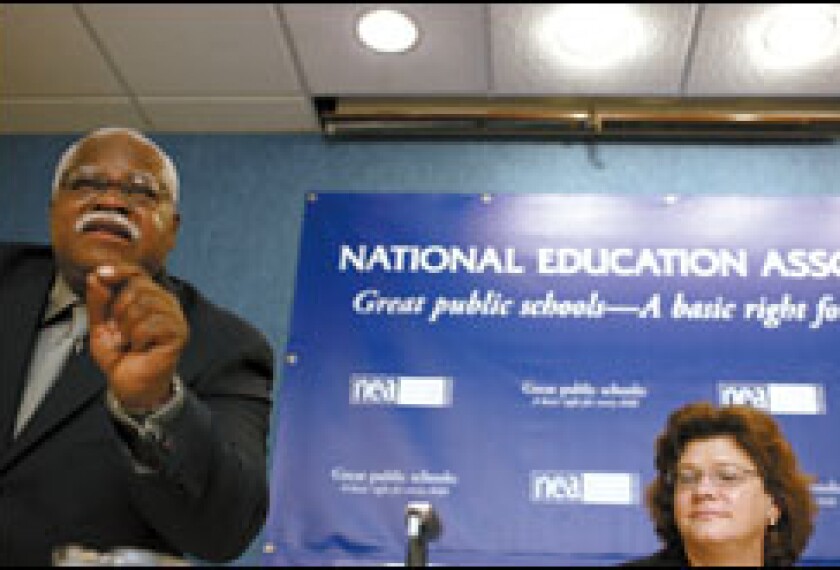Union President Reg Weaver addresses a reporter's question at the National Press Club last week, while Kathryn Brown, a senior vice president of Verizon, listens.