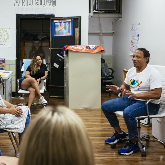 Dean Jermaine Weems (right) tells a story about fostering kittens to teachers and faculty during a Welcome Back training at CICS Bucktown on Monday, Aug. 15, 2022 in Chicago, Ill.