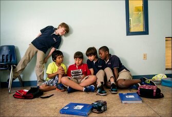 Mater Beach Academy 3rd graders, from left, Gabriel Galan, Jason Salduende-Munoz, Thomas Valenziano, Sebastian Orozco, and Kevin Guette, play a video game at the Miami Beach, Fla., school. In 2010, the academy switched from being a Catholic to a charter school.