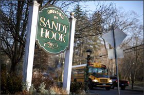 A school bus drives past a lamppost decorated for the holidays in Newtown, Conn. With winter on their doorstep once again, the people of Newtown are bracing for the day everyone there simply calls “12/14”— referring to the day last year when 26 people were killed by a gunman inside Sandy Hook Elementary School.