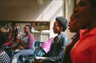 Lindblom Math & Science Academy freshman Kemba Rasul, center, sings during a choir class.