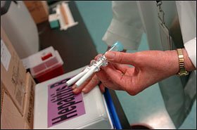 A nurse prepares syringes with hepatitis B vaccine at the Southeastern Health Center in Laurel, Md. Changes in state immunization policies create challenges for school officials.