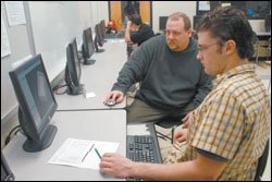 Eric Thomas (left), a former signmaker, works in a classroom adjacent to brother Mark's in Soddy-Daisy. As part of Project Lead the Way, a nationwide pre-engineering program, they participated in intensive teacher training that Eric calls "boot camp." Each brother works in a classroom equipped with cutting-edge hardware and software, and they're trying to chip away at the attrition rate for college engineering students, which exceeds 50 percent.