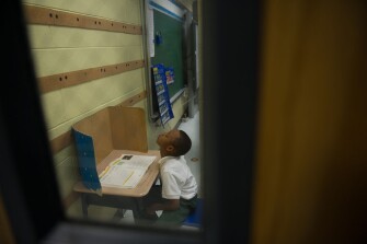 Dajon Davis, a 7-year-old 1st grader at Dr. Martin Luther King Jr. Charter School in New Orleans' Lower 9th Ward, works on a word search assignment.