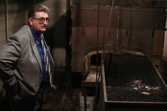 Terry George, the state-appointed school superintendent in Fayette County, stands next to the broken furnace and a coal bin sprinkled with asbestos chips that had fallen from the ceiling above. A controversial school consolidation plan would have shuttered some schools and include a new $56 million high school.