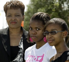 Feleccia Moore-Davis, left, is unsure about transportation for her daughters, Remi Davis, center, and Michaela Davis, right, now that the Cypress-Fairbanks Independent School District in Texas has decided to stop busing students who live within two miles of their school this year.