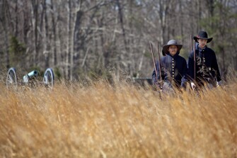 Antonio Aquino, right, and Angel Aviles lead a line of 6th graders from Stonewall Jackson Middle School, in Manassas, Va., as they reenact 1861 military life at the Manassas National Battlefield Park. They are working with Journey Through Hallowed Ground to produce short videos exploring a variety of aspects of civilian and military life leading up to and during the Civil War.