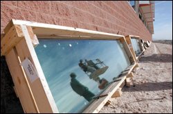 Glaziers are reflected in a window during construction of a new high school in Clark County, Nev. The district, which includes Las Vegas, opens an average of one new school a month to accommodate its booming enrollment.