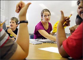 Ms. Morgan leads a group of students at Blair Elementary through a lesson. She spent five years developing a program that allowed her special education students to spend half their days in regular classrooms, supported by teaching assistants. Now that the teaching assistants are targeted for layoffs, Ms. Morgan worries that her students will have to spend their days in self-contained classes next school year.
