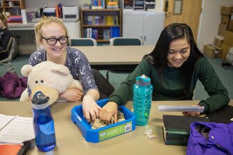 Seventeen-year-old Atheina, left, and Luxxus, 16, practice memorizing a speech during class. Students are often seen with items like fidget spinners, modeling clay, or even moon sand and plush toys as pictured here. “When you are looking at trauma-informed care, a lot of what we strive to do is teach them how to regulate,” said Christine Jones, the superintendent of the school. “A lot of kids who have been traumatized are at a heightened baseline: Their heart rate is higher, you’ll see a lot of girls jiggling their feet all day long. If you look at the crisis cycle, they are halfway up all the time. The stress toys, calming music … it’s all connected to help them keep themselves calm and focused.”