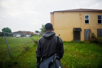 J’Remi Barnes, a recent graduate of New Orleans’ Sci Academy, walks to the bus stop in May. A college scholarship to a distant school could pave the way to a better life for his family.