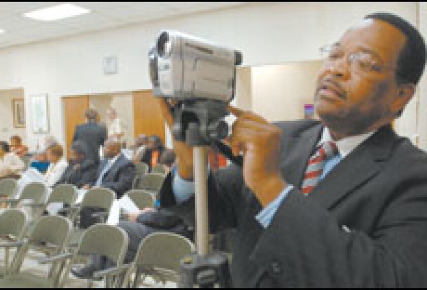 Ronald E. Jackson, the executive director of Citizens for Better Schools in Birmingham, Ala., prepares to address his city’s school board last week. The group is pressing for stronger federal enforcement of the No Child Left Behind Act’s school choice provision.