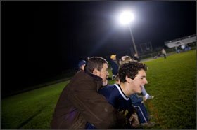 Kurt Koch, hugs his son, Joey Koch, on the sidelines of the match.