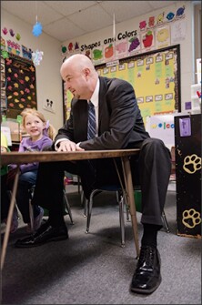 Kindergartner Abigail Payne smiles at Superintendent Steve Webb during his visit to Goreville Elementary School. Webb’s district is trying to adjust to Illinois’ more stringent requirements for principal training.