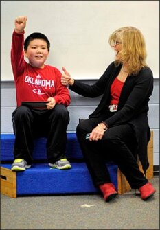 Baker-Butler Elementary School librarian Anita Mays congratulates 3rd grader Jacky Gao, after he successfully completed a “maker” challenge. The local school district has taken an aggressive approach in integrating maker spaces into classrooms.