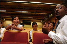 Tran Vo, left, a participant in a migrant education program in Chester County, Pa., talks with Imani Powell, right, of West Chester University last year about college admissions.